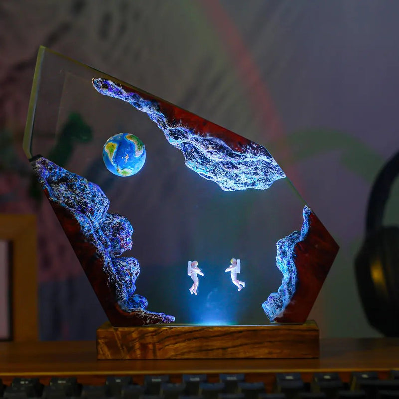 Floating astronauts and Earth resin lamp glowing blue