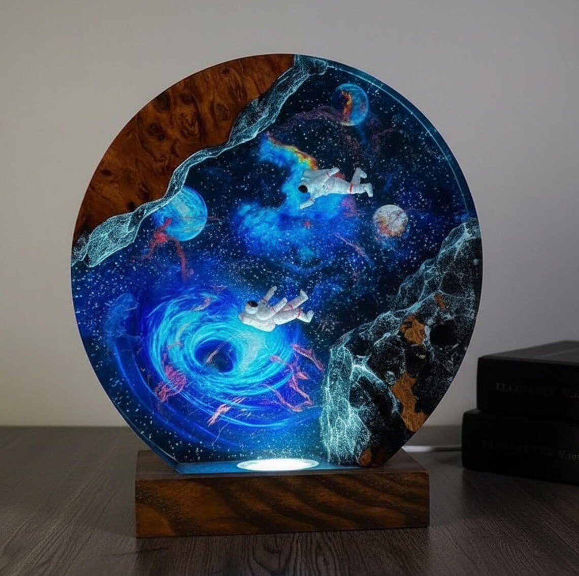 Round astronaut galaxy resin lamp with black hole spiral on a wood base