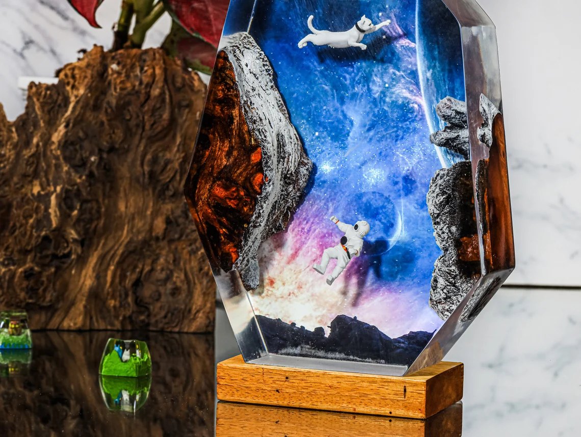 Close view of the cat and astronaut floating in the galaxy