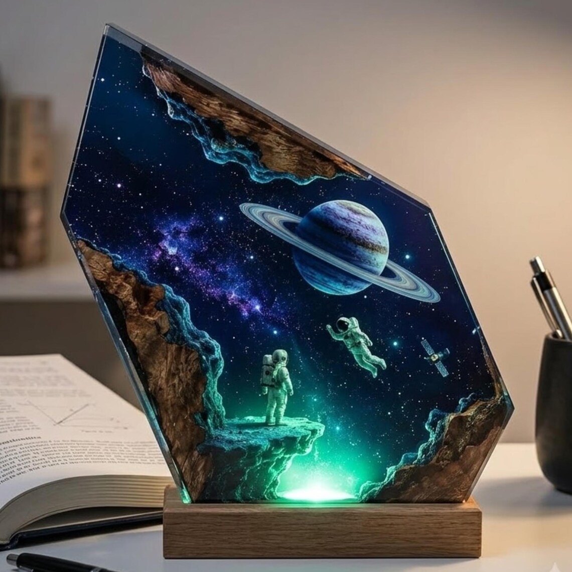 Astronaut galaxy resin lamp glowing green on a desk