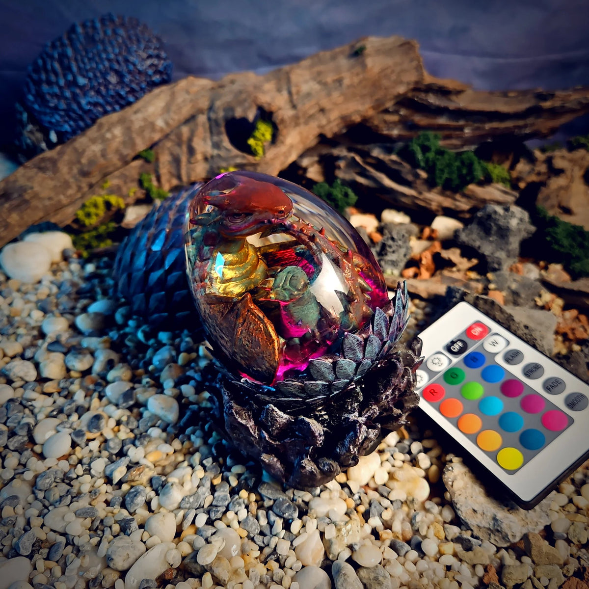 Dragon egg resin lamp with a bronze baby dragon glowing magenta