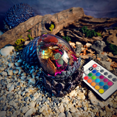 Dragon egg resin lamp with a bronze baby dragon glowing magenta