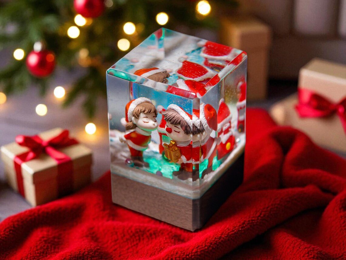 Christmas couple resin cube near a Christmas tree