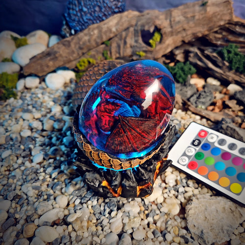 Crimson dragon egg lamp glowing red and blue with remote