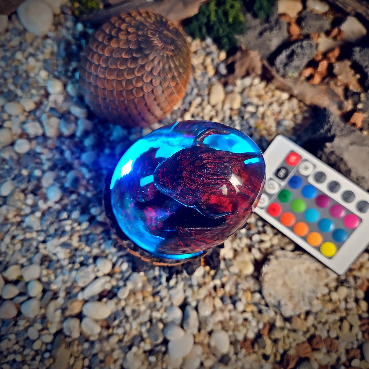 Top view of the crimson dragon egg lamp glowing cyan