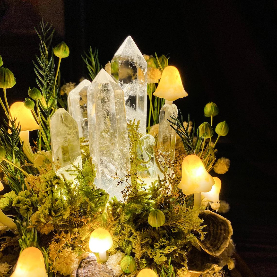 Close-up of clear crystal points and glowing mushrooms
