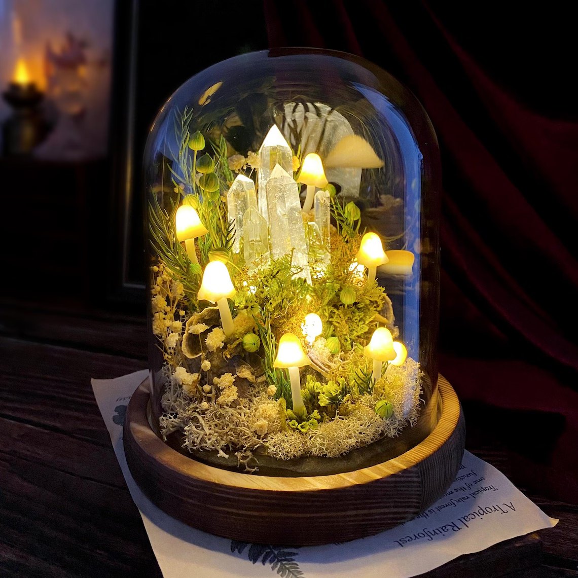 Glass dome mushroom night light glowing on a wooden table