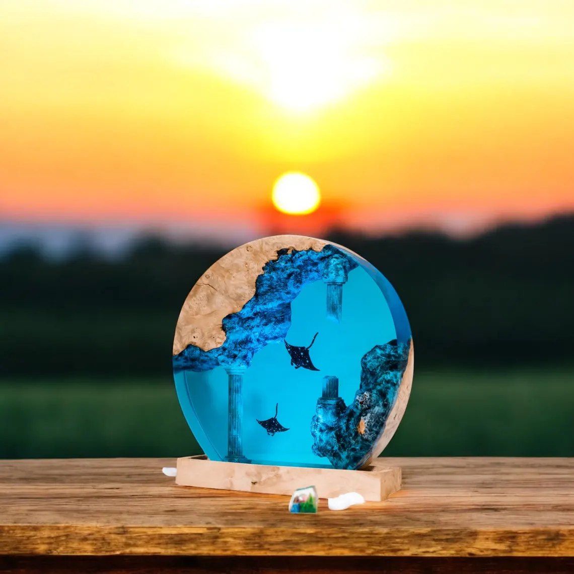 Round eagle ray resin lamp in front of a setting sun