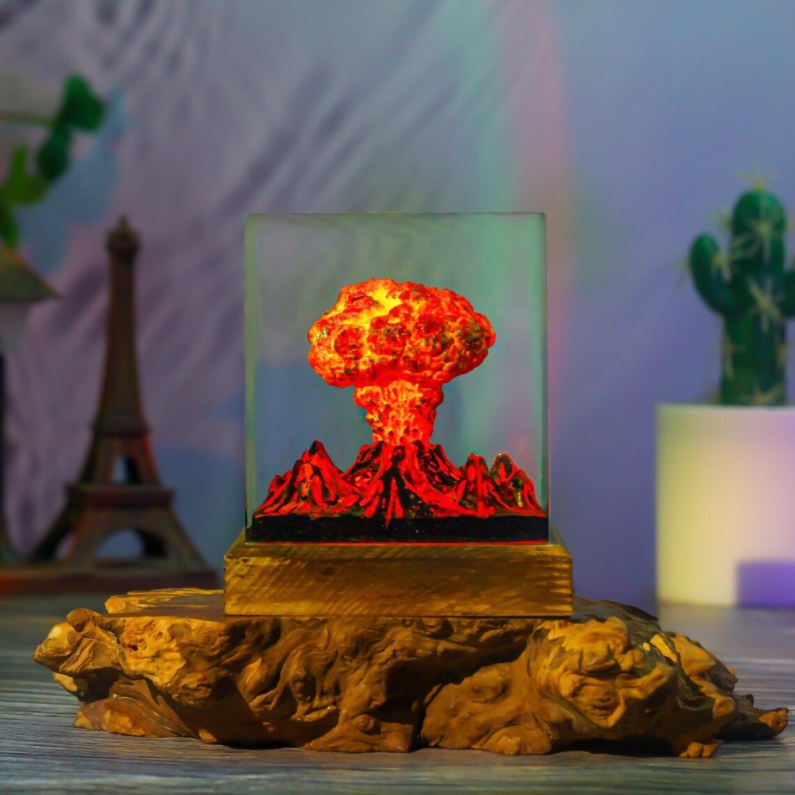 Volcano eruption resin lamp displayed on a root-wood stand