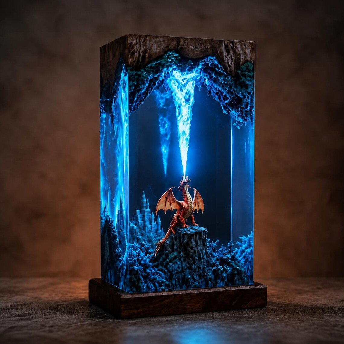 Dragon resin lamp glowing blue on a dark wood base