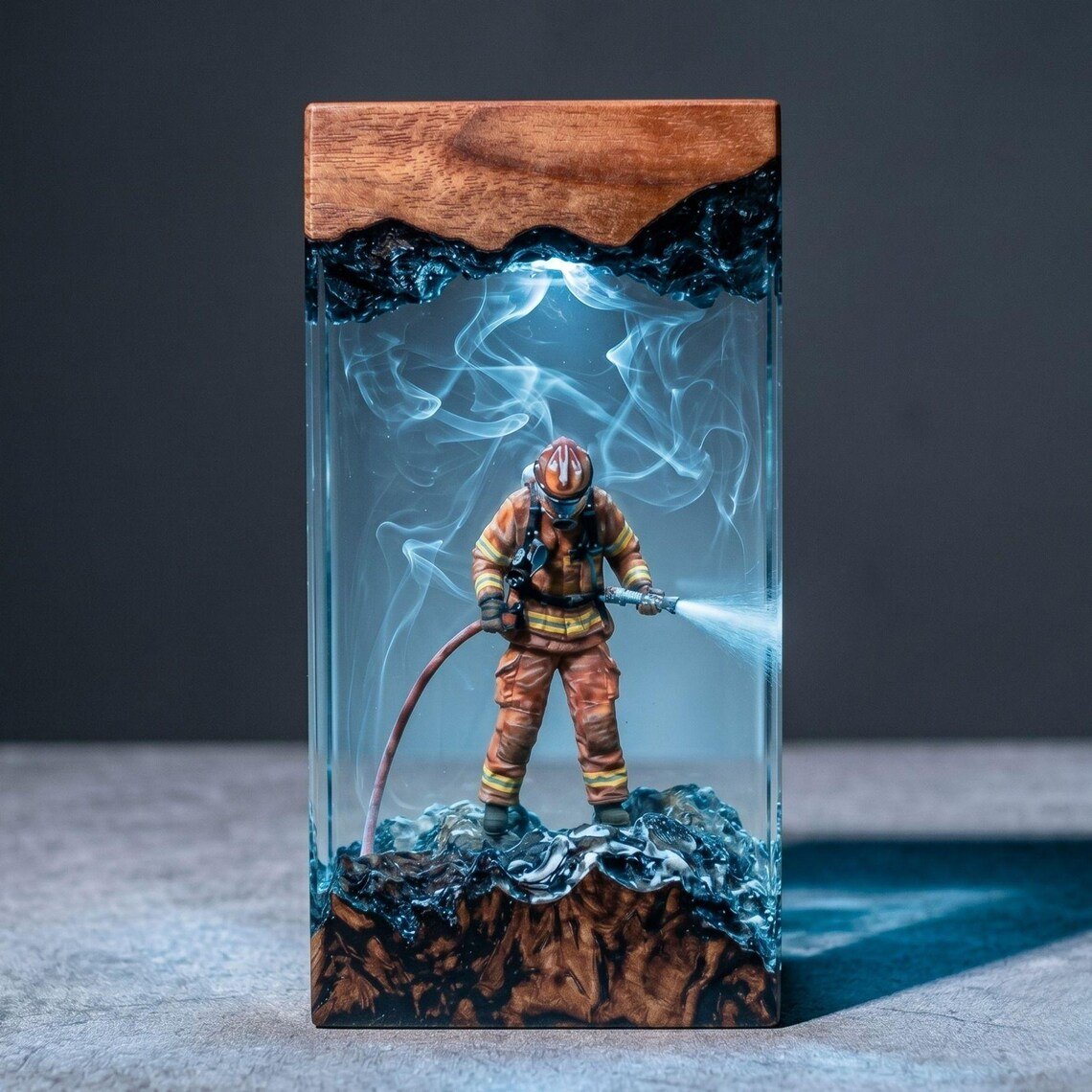Firefighter resin lamp glowing blue-white with natural wood top