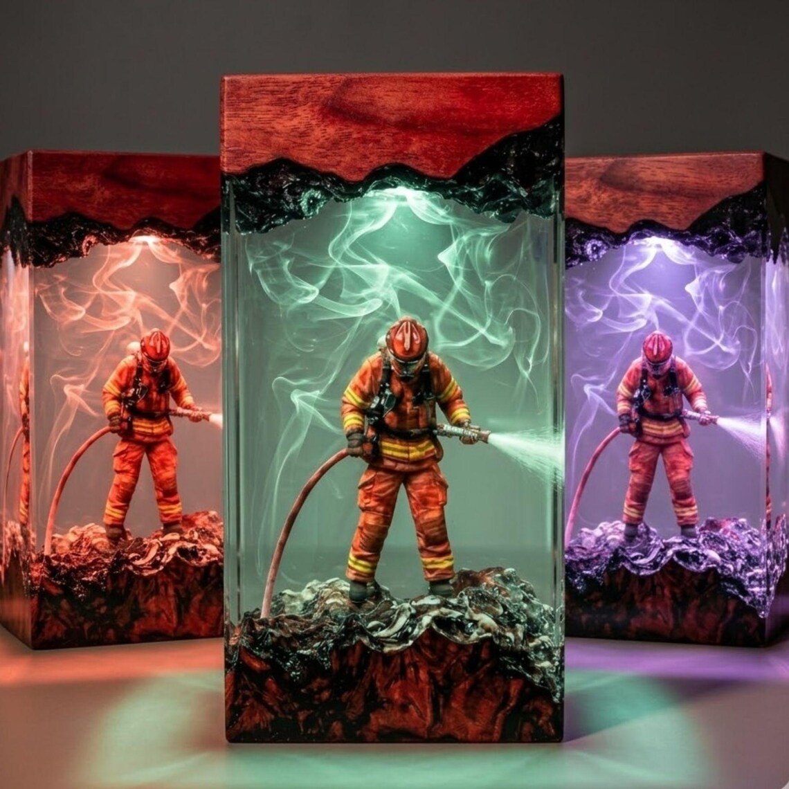 Three firefighter resin lamps glowing red, green and violet