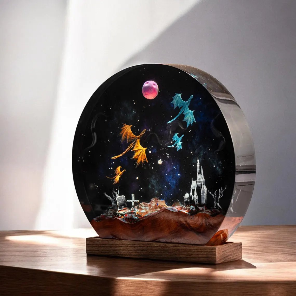 Round galaxy dragon resin lamp in sunlight on a wood shelf