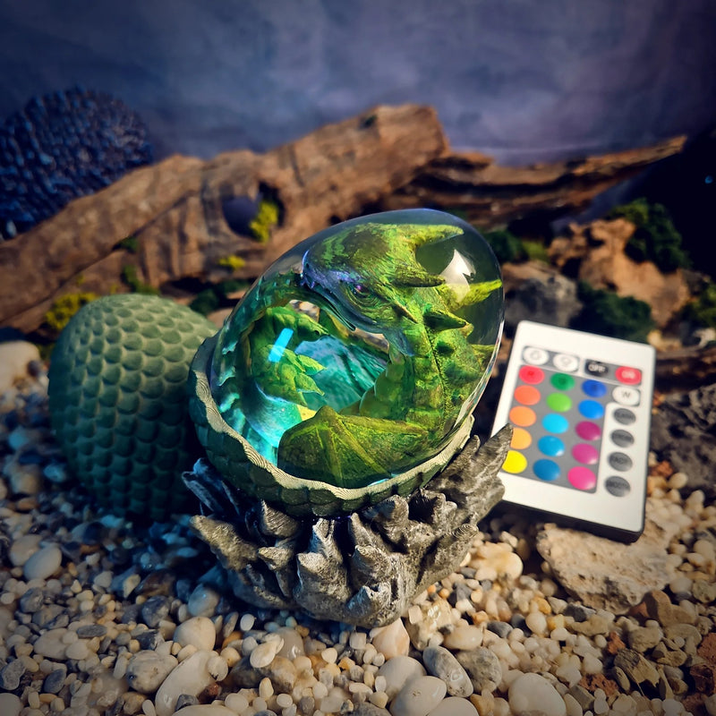 Dragon egg resin lamp with a green baby dragon glowing aqua
