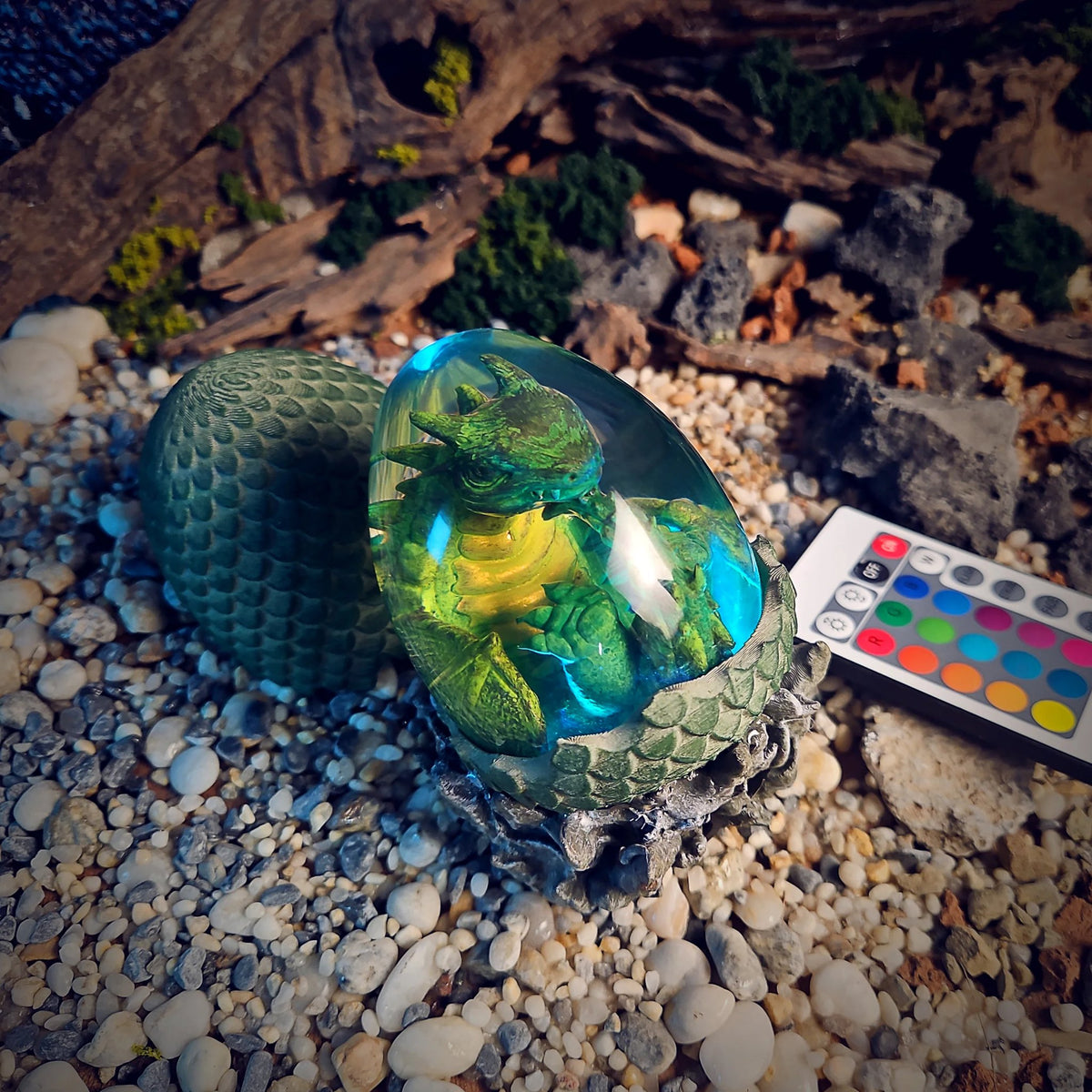 Dragon egg lamp with green hatchling glowing cyan and yellow