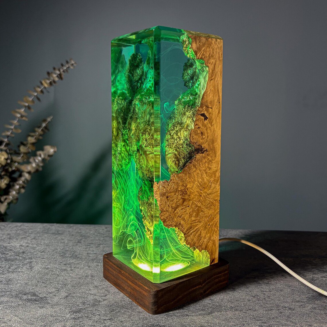 Moss resin lamp showing burl wood face and green glow