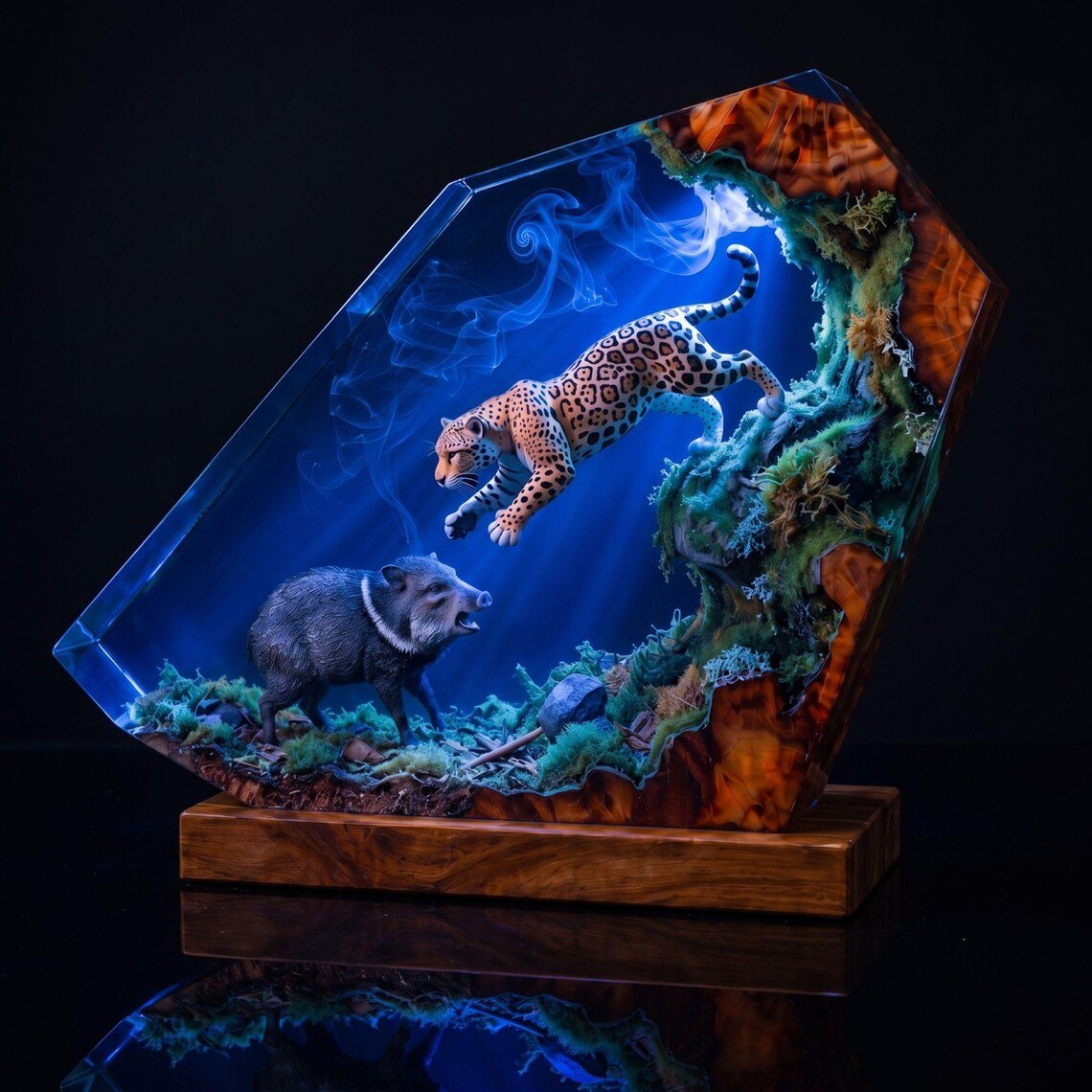 Jaguar resin lamp lit in blue on a dark reflective surface