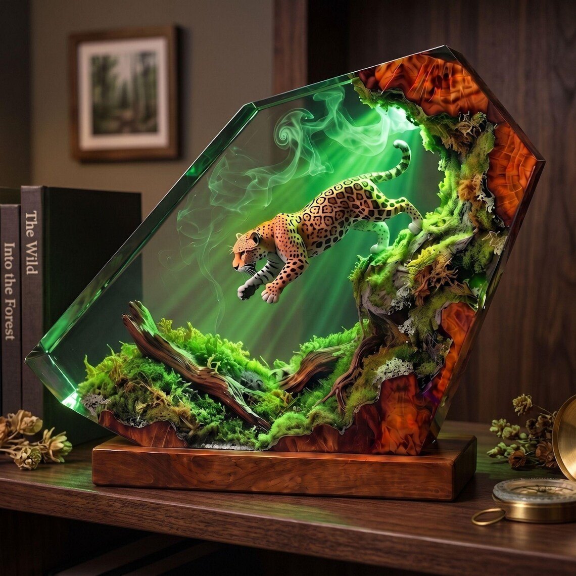 Jaguar forest resin lamp beside books and a compass
