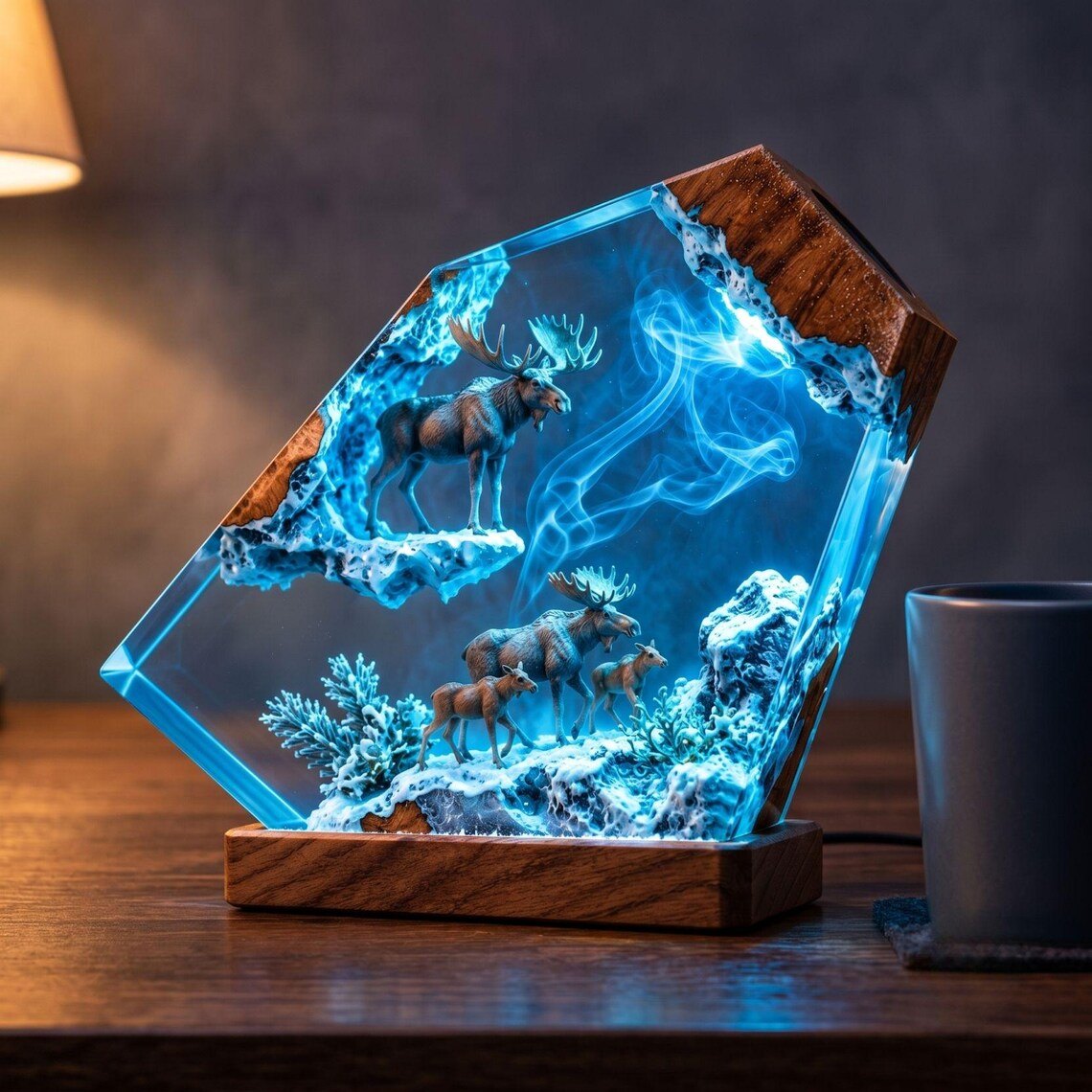 Moose family resin lamp next to a mug