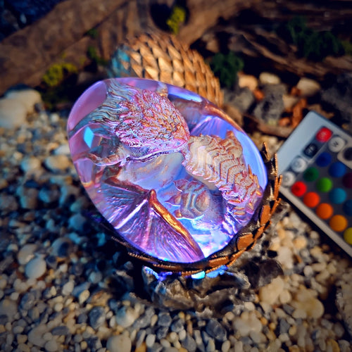 Close-up of the pearl white dragon egg glowing lilac