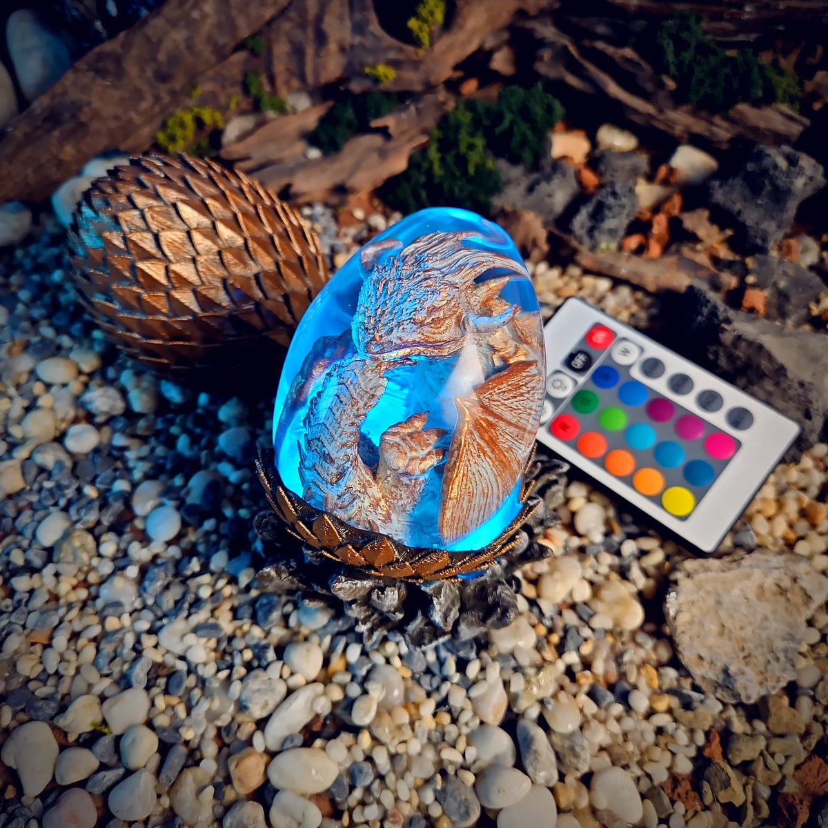 Pearl white dragon egg lamp glowing blue with remote
