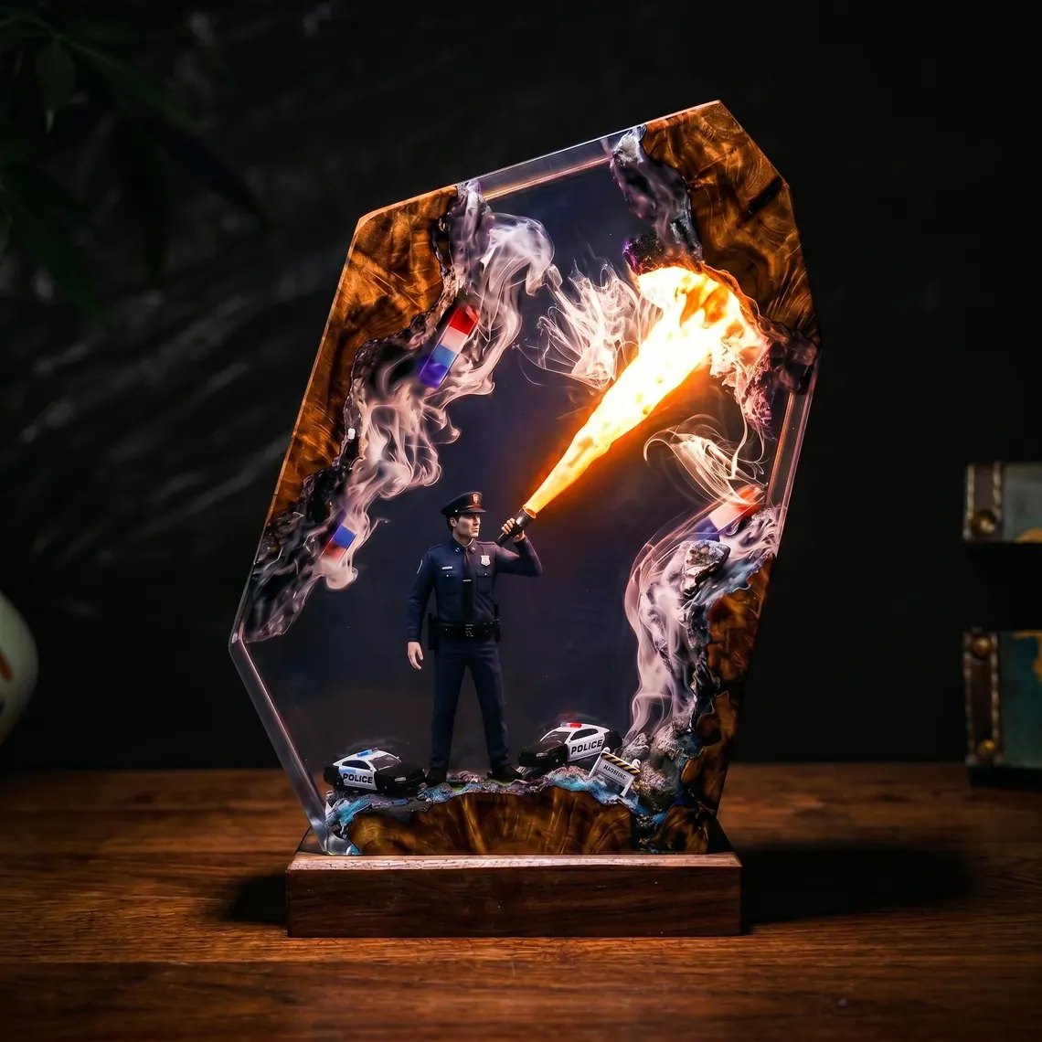 Police officer resin lamp with flashlight beam glowing warm orange