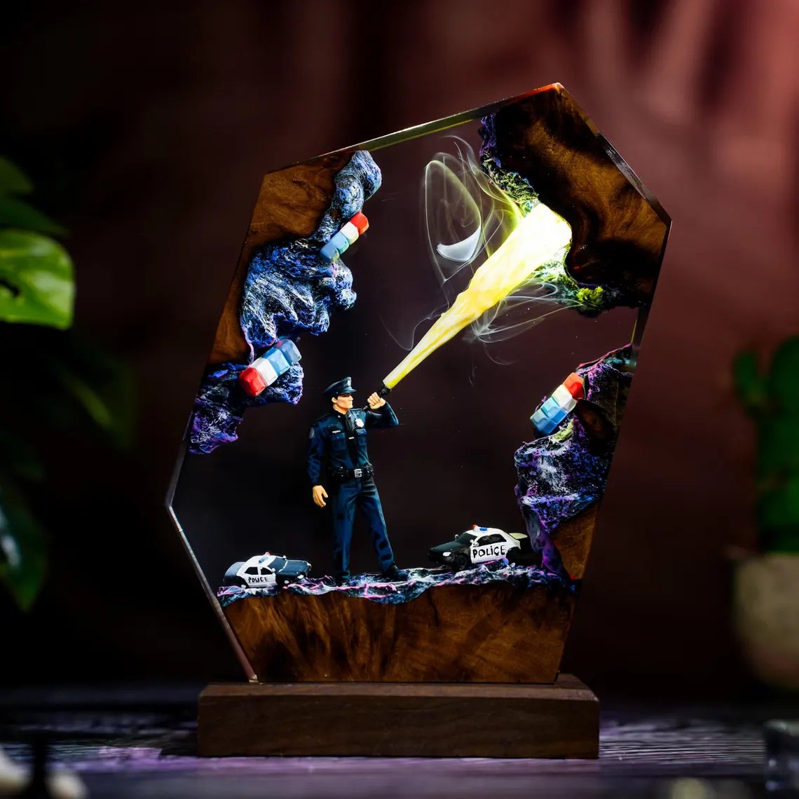 Police officer resin lamp with warm beam and smoke, angled view