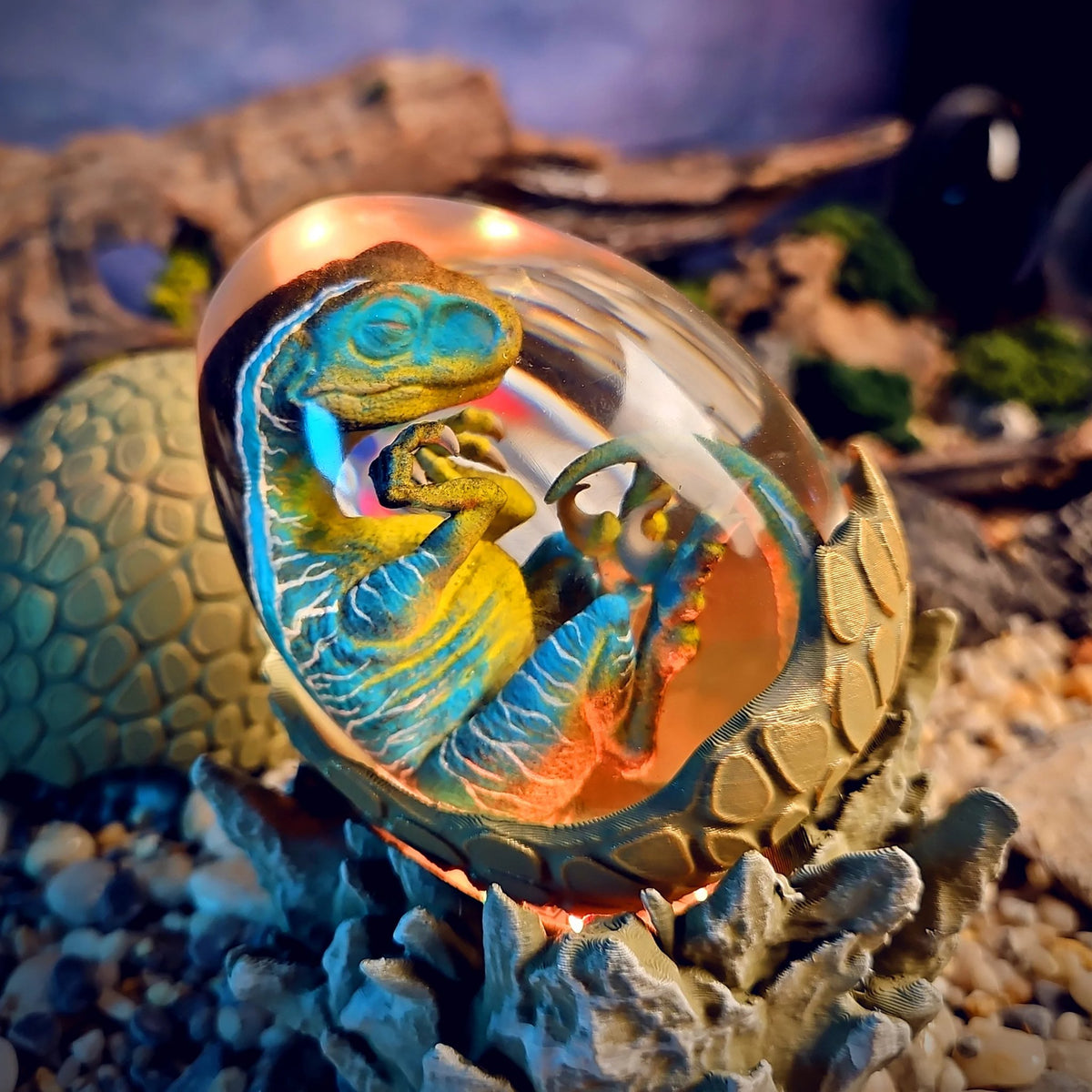 Dinosaur egg resin lamp with a curled raptor embryo glowing amber