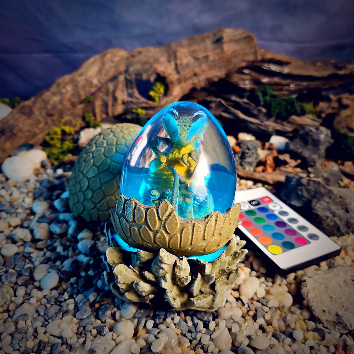 Dinosaur egg lamp glowing aqua blue with remote