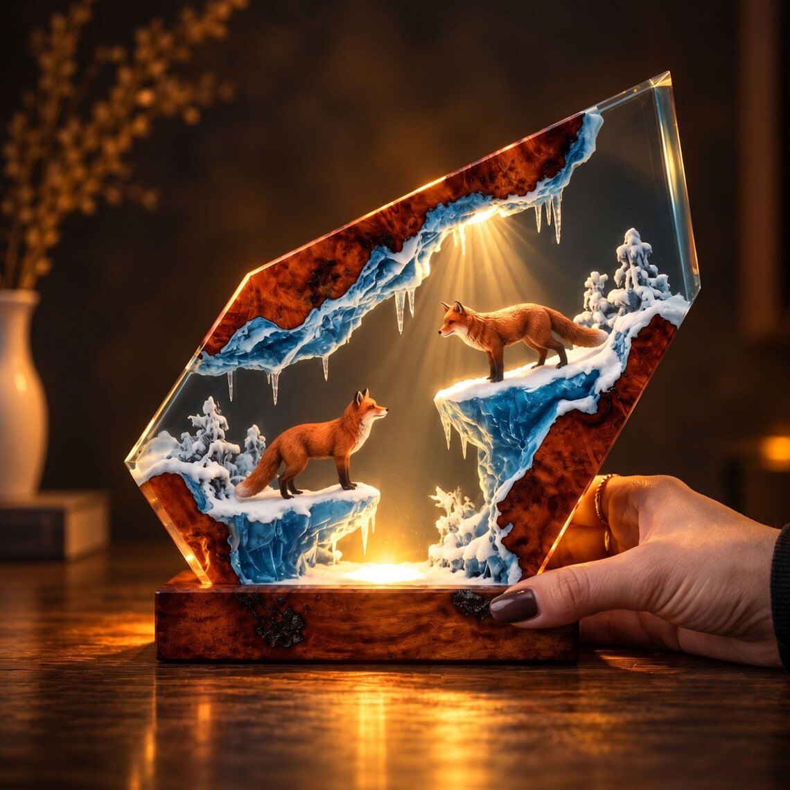 Hand beside the fox resin lamp showing the burl wood base
