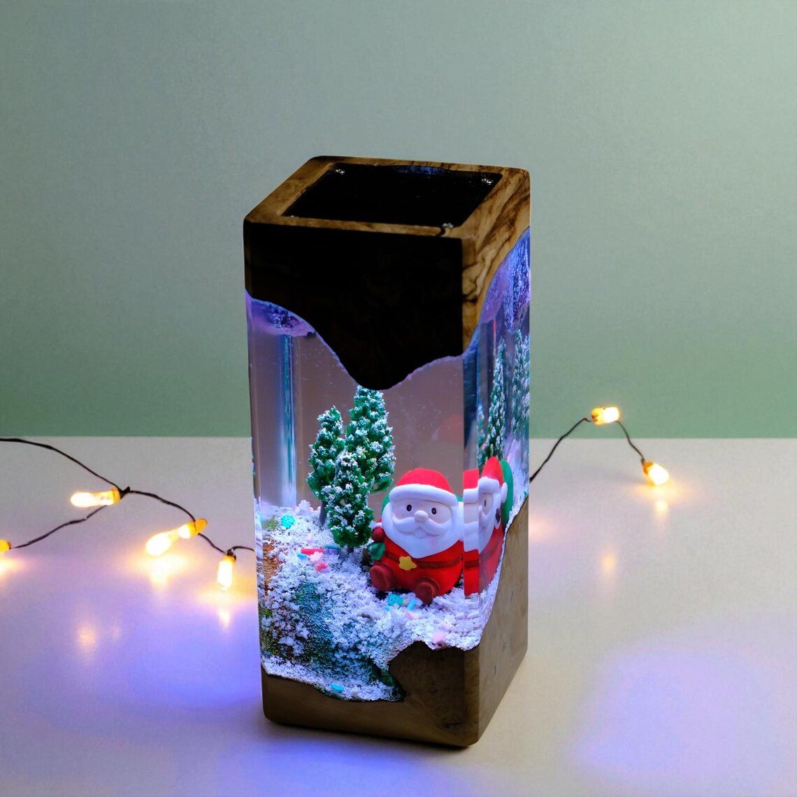 Santa snow scene resin lamp in dark wood with string lights