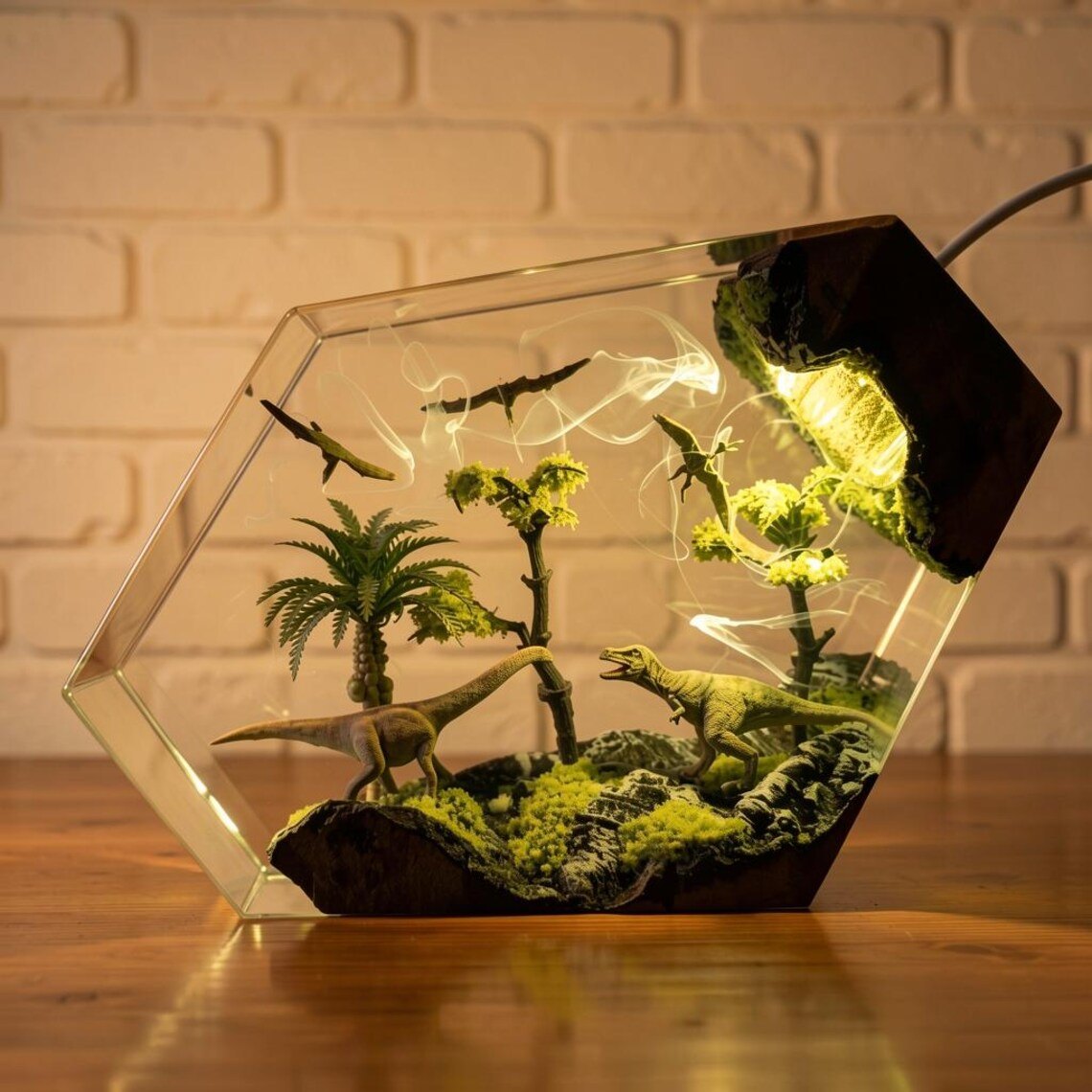 Dinosaur resin lamp with a sauropod and palm trees glowing warm yellow