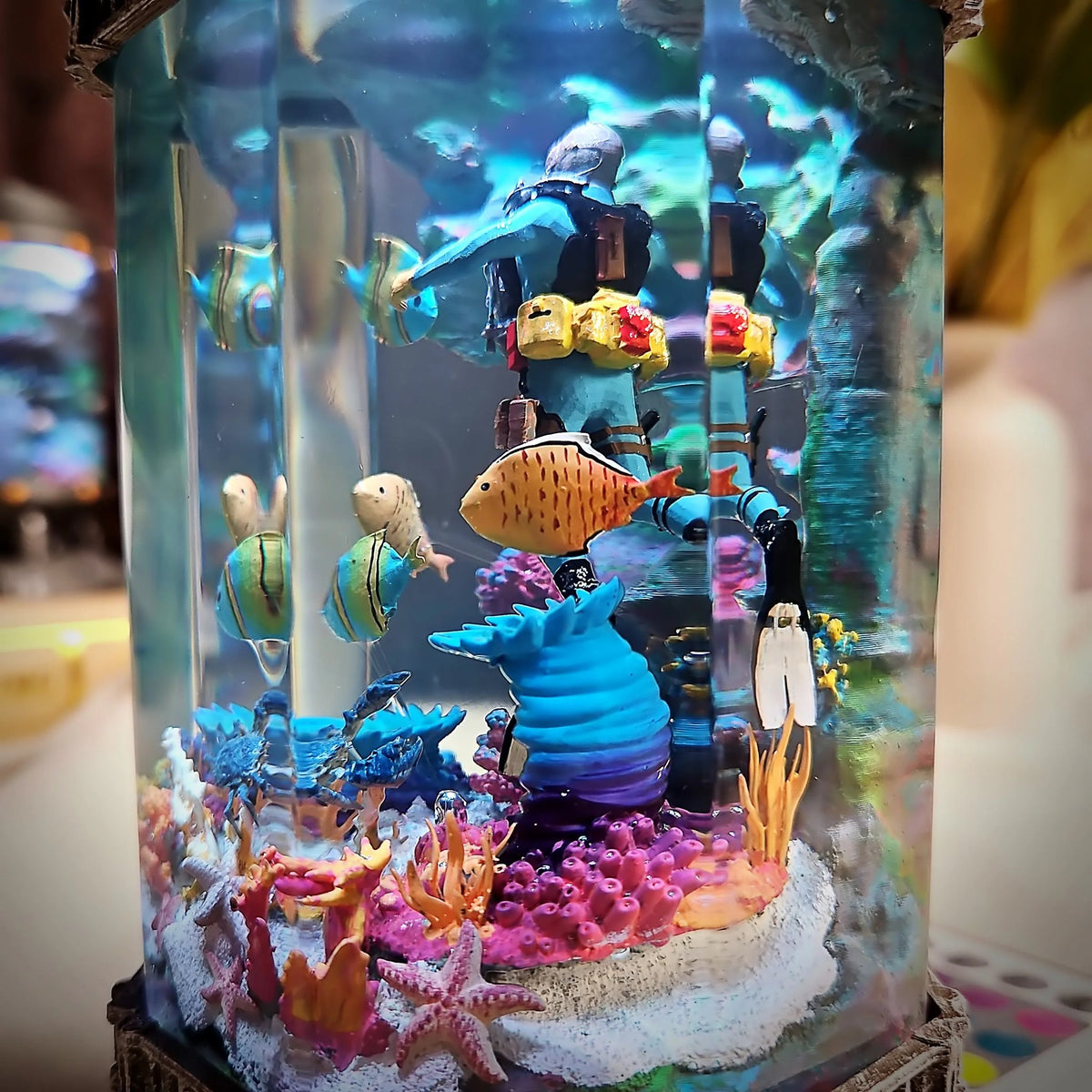 Close-up of coral, starfish and striped fish in the resin lamp