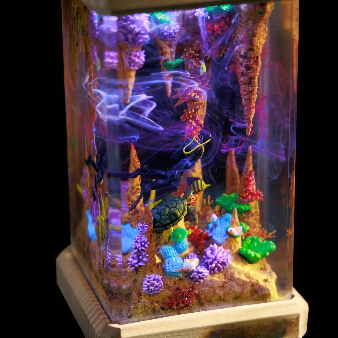 Close-up of the lit sea cave with diver and sea turtle
