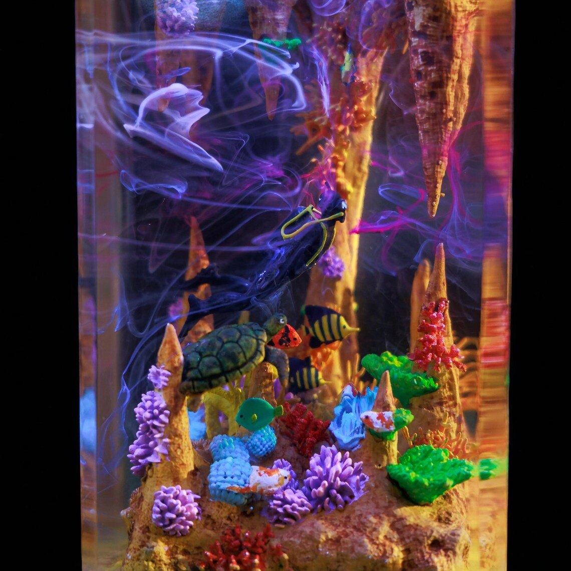 Detail of diver, turtle and coral glowing in the cave