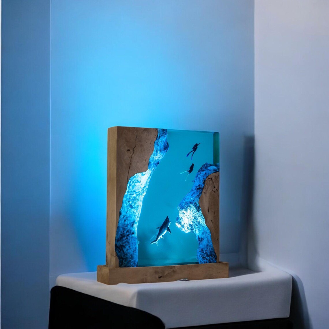Shark resin lamp glowing blue in a corner