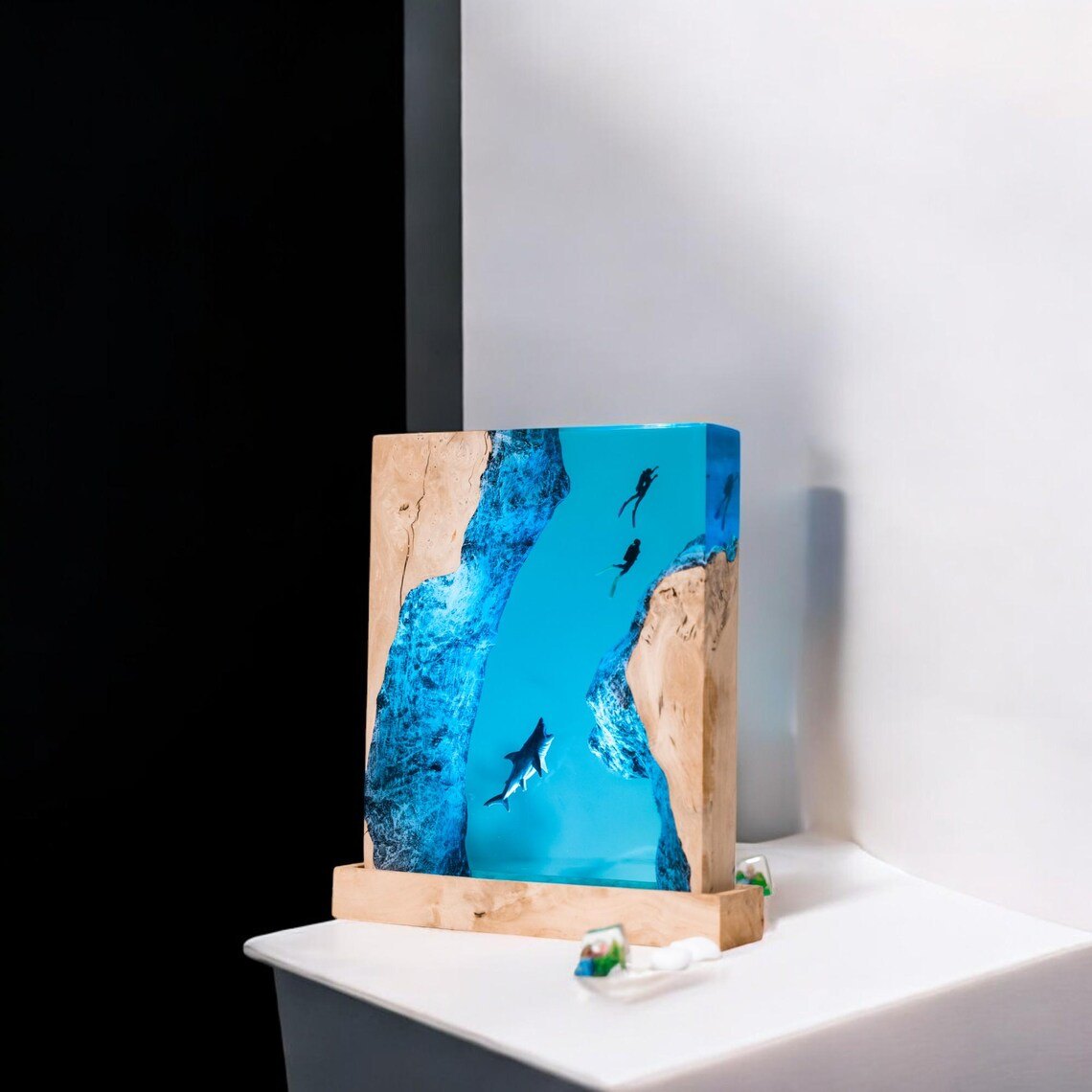 Angled view of the shark and divers resin lamp