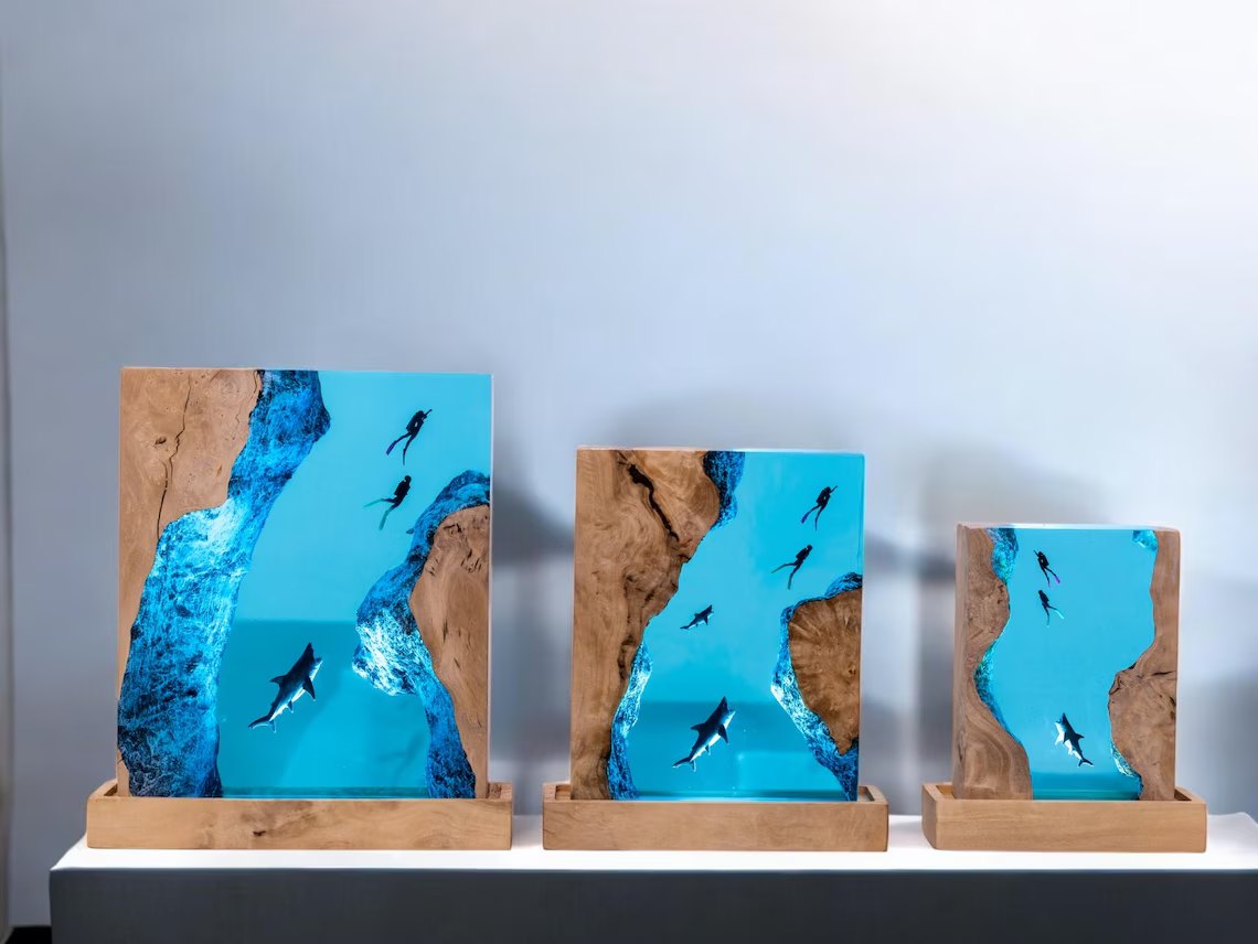 Three shark resin lamps of different sizes side by side