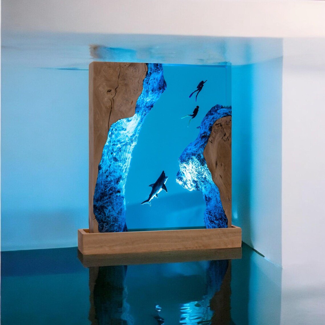 Shark and divers resin lamp reflected on a dark surface