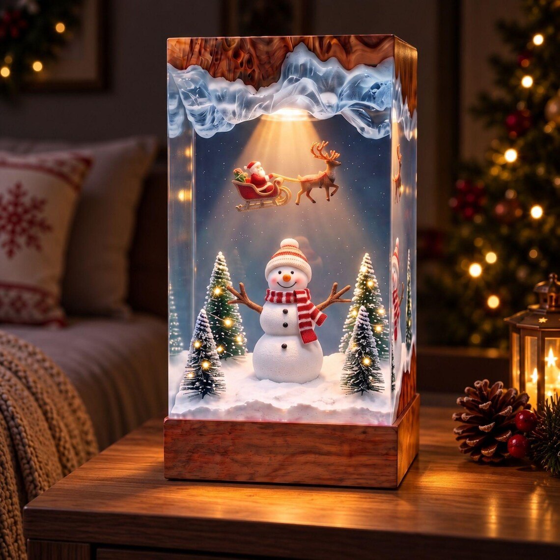 Snowman and sleigh resin lamp beside a lantern