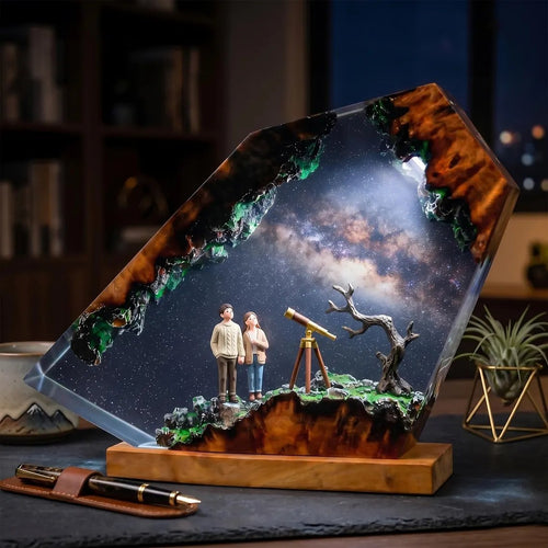 Stargazing couple resin lamp with Milky Way on a desk
