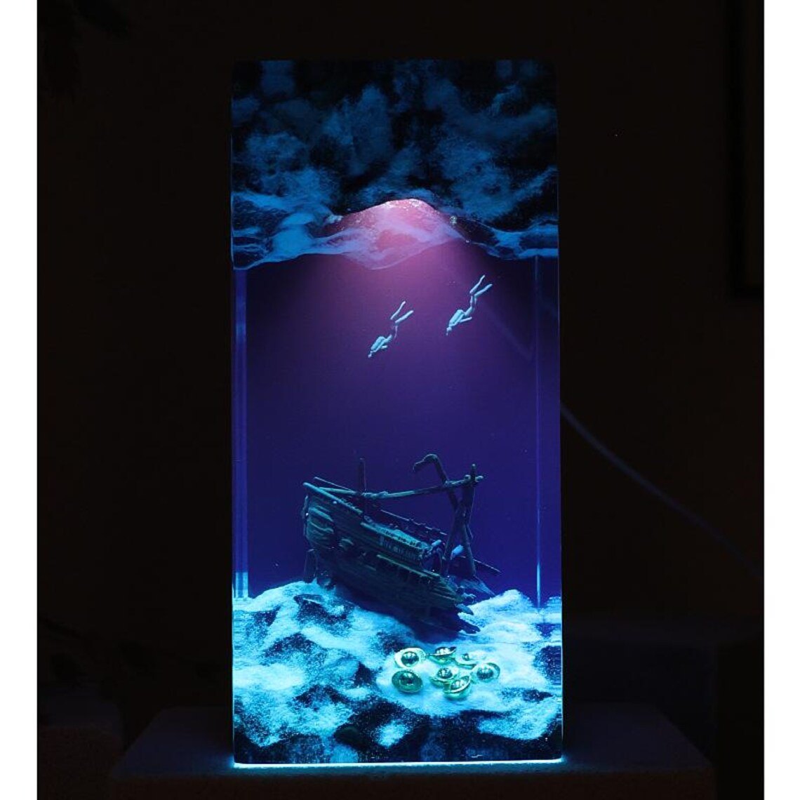Shipwreck resin lamp glowing violet blue in the dark