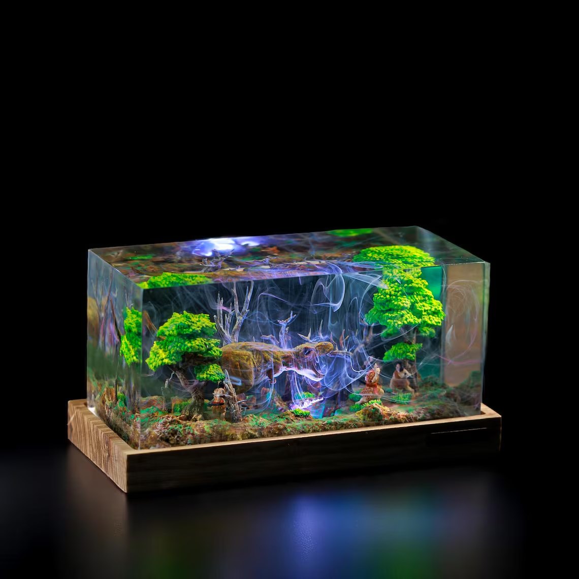 T-Rex forest diorama resin block lit from above on a wood base