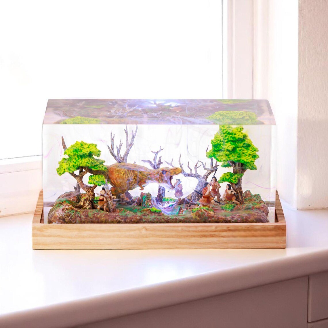 T-Rex forest diorama resin lamp on a white windowsill