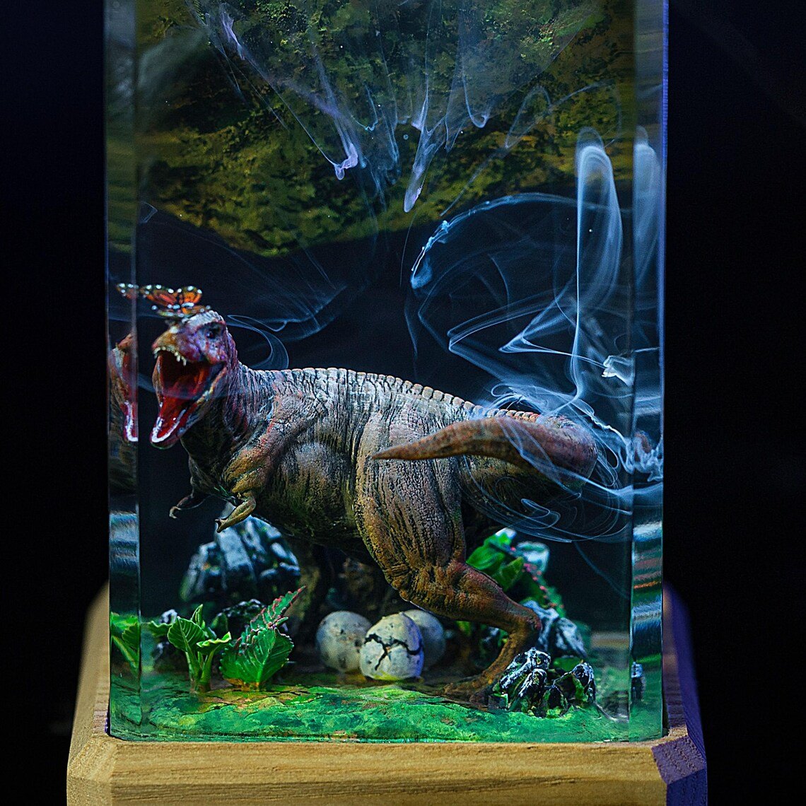 Close-up of the roaring T-Rex with a butterfly and cracked eggs