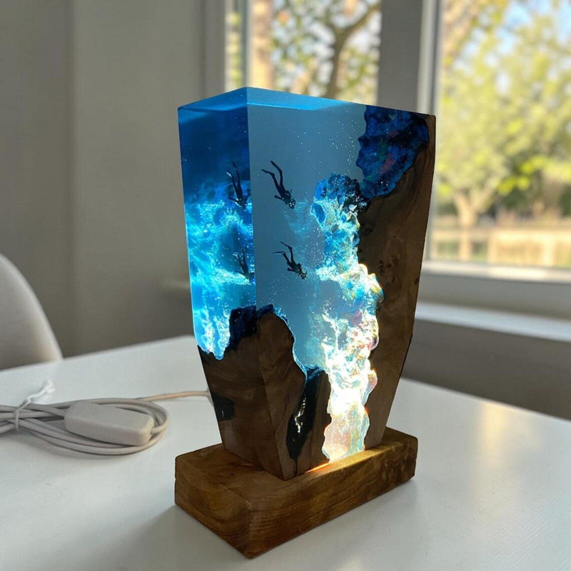 Two divers resin lamp with burl wood on a white table