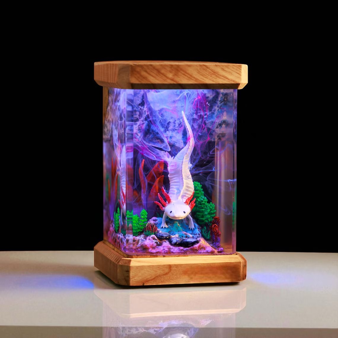Axolotl resin lamp glowing violet on a white shelf