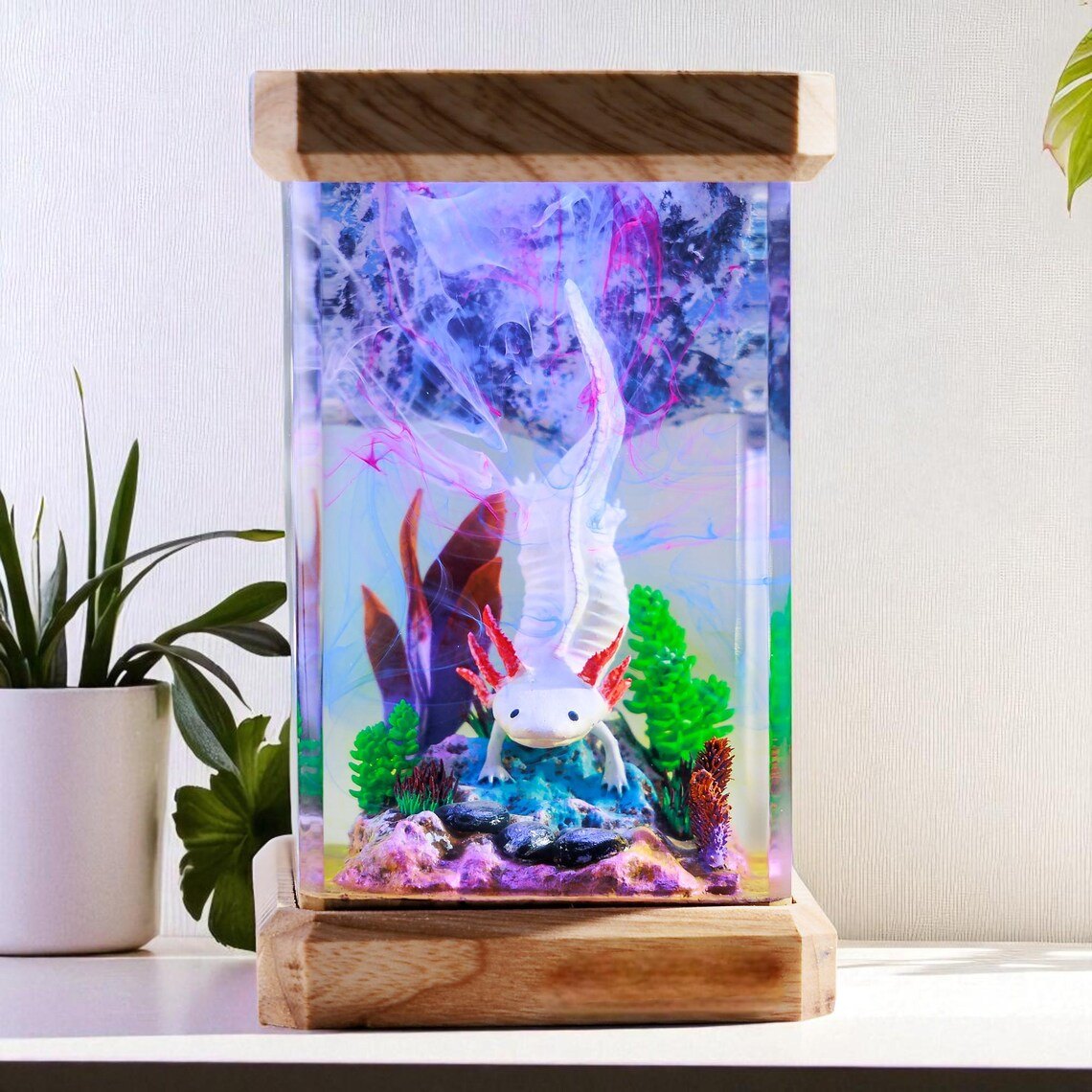 Axolotl resin lamp beside a plant on a white table