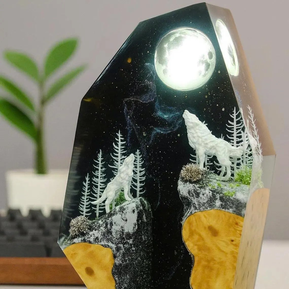 Two white wolves howling at a glowing full moon resin lamp