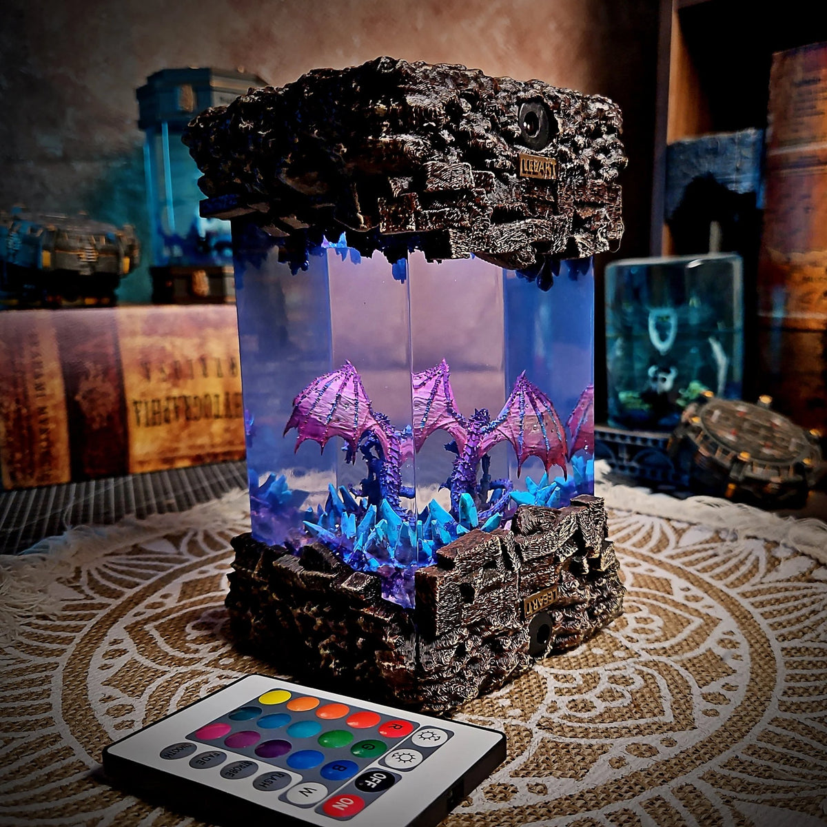 Dragon resin lamp with stone-textured top and base glowing violet
